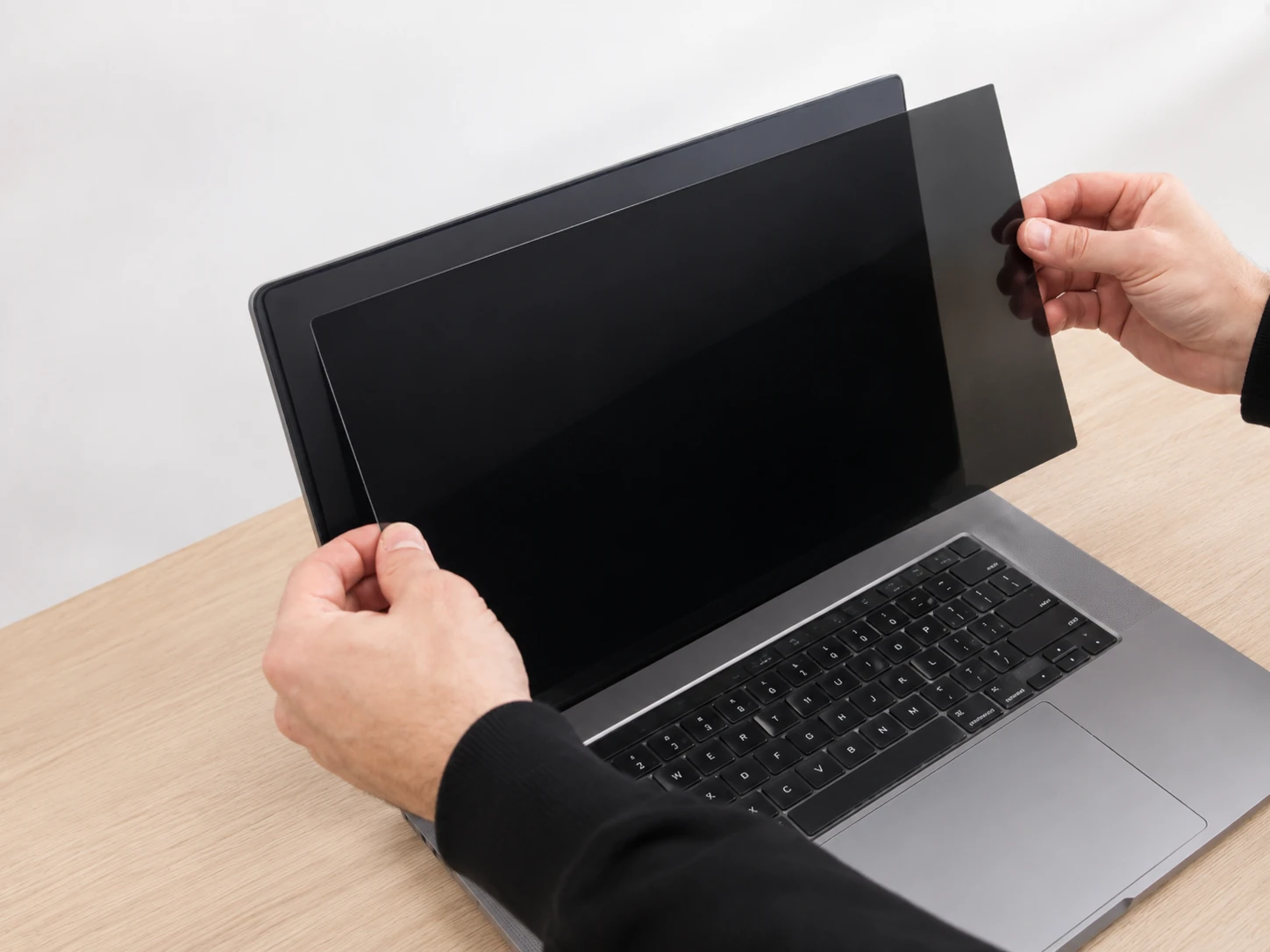 Checking whether the adhesive privacy filter fits the laptop screen