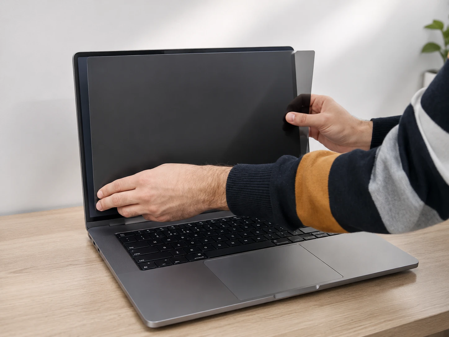 Checking the fit of a privacy filter on a laptop screen